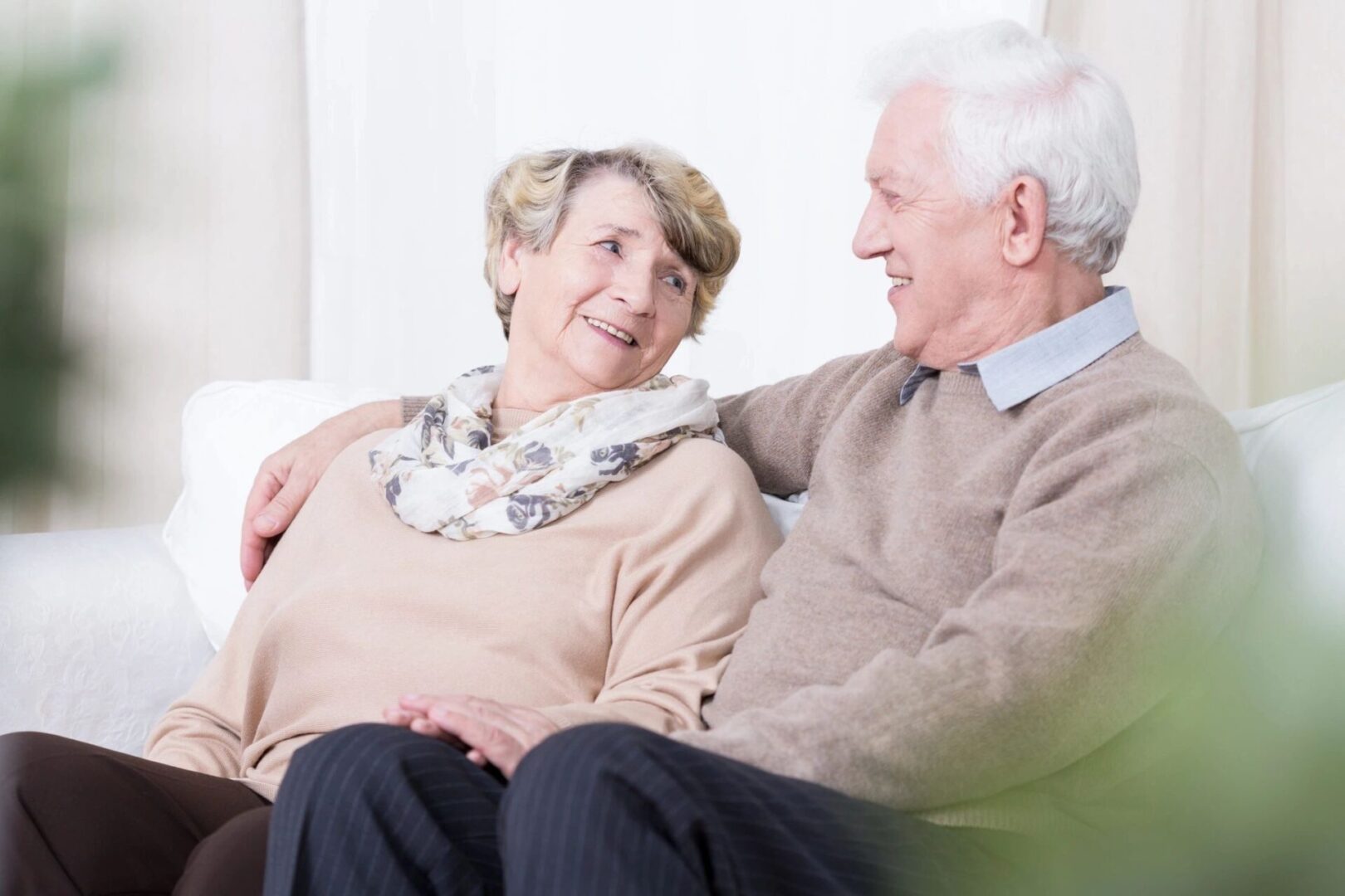 A man and woman sitting on top of a couch.